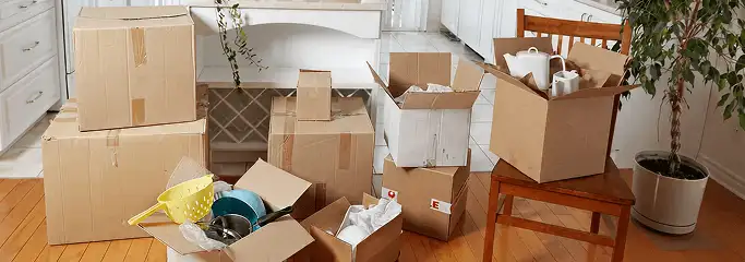 Packed moving boxes and household items in a kitchen before move-out or move-in cleaning, Lakeland, FL.